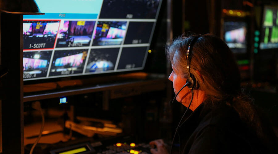 a recording technician looking at a monitor